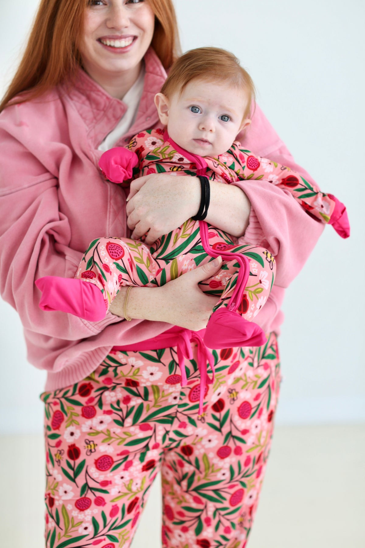 Mother holding baby in the Petals & Pomegranates bamboo zippy by Shiloh & Kate