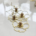 Sculptural brass poppy flower earrings with French hook ear wires