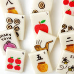 Handcrafted Rosh Hashanah marzipan mahjong tiles featuring apples, honey, pomegranates and shofars by Marzipops