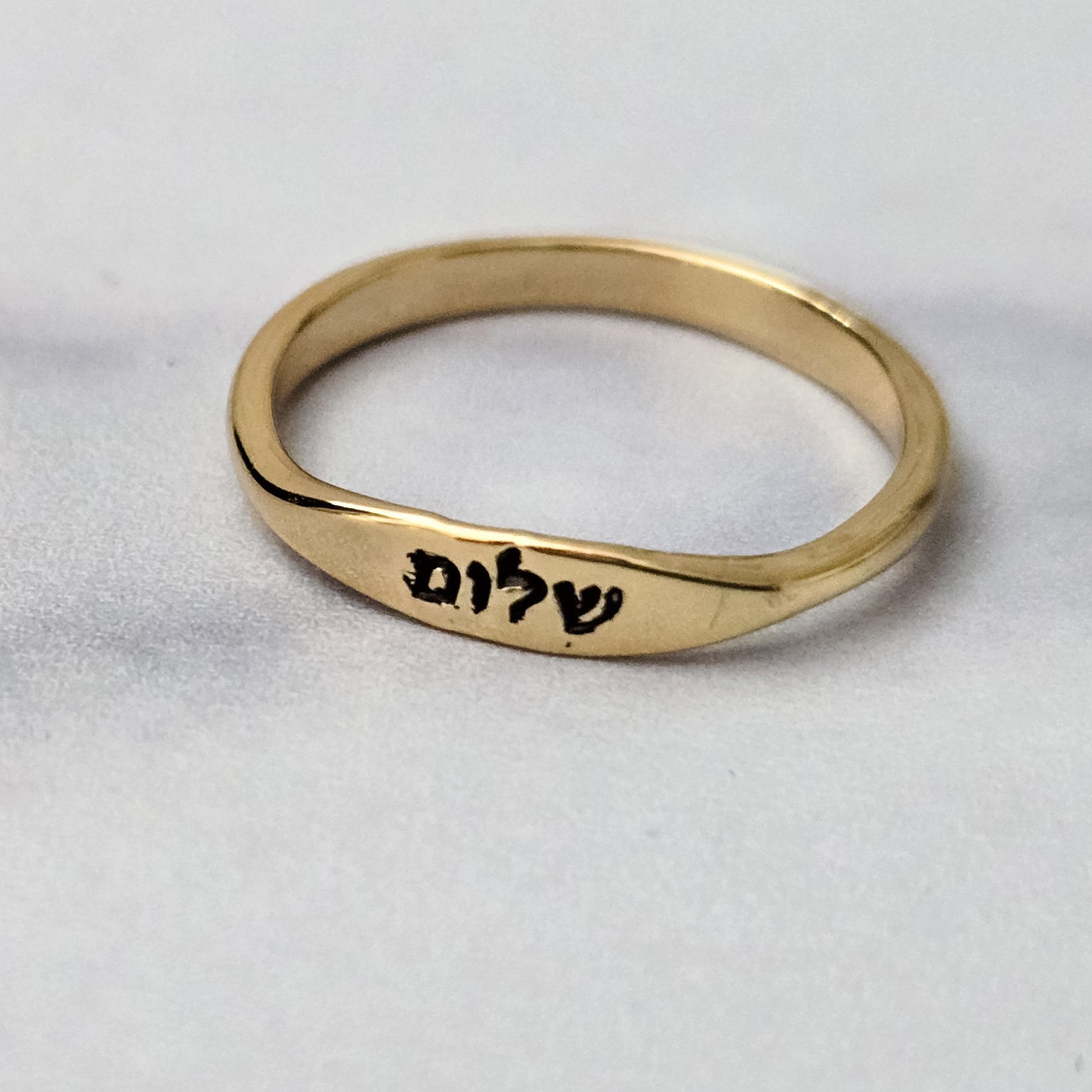Hand-stamped Shalom Hebrew ring shown from above