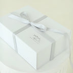 White Shiloh & Kate baby gift box tied with a satin ribbon, ready for gifting at a baby shower, bris, or baby naming.