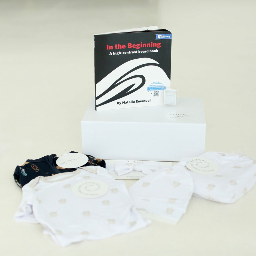 Shiloh & Kate Jewish baby gift set with Star of David swaddle, newborn gown, matching hat, PJ Library board book, and gift box.