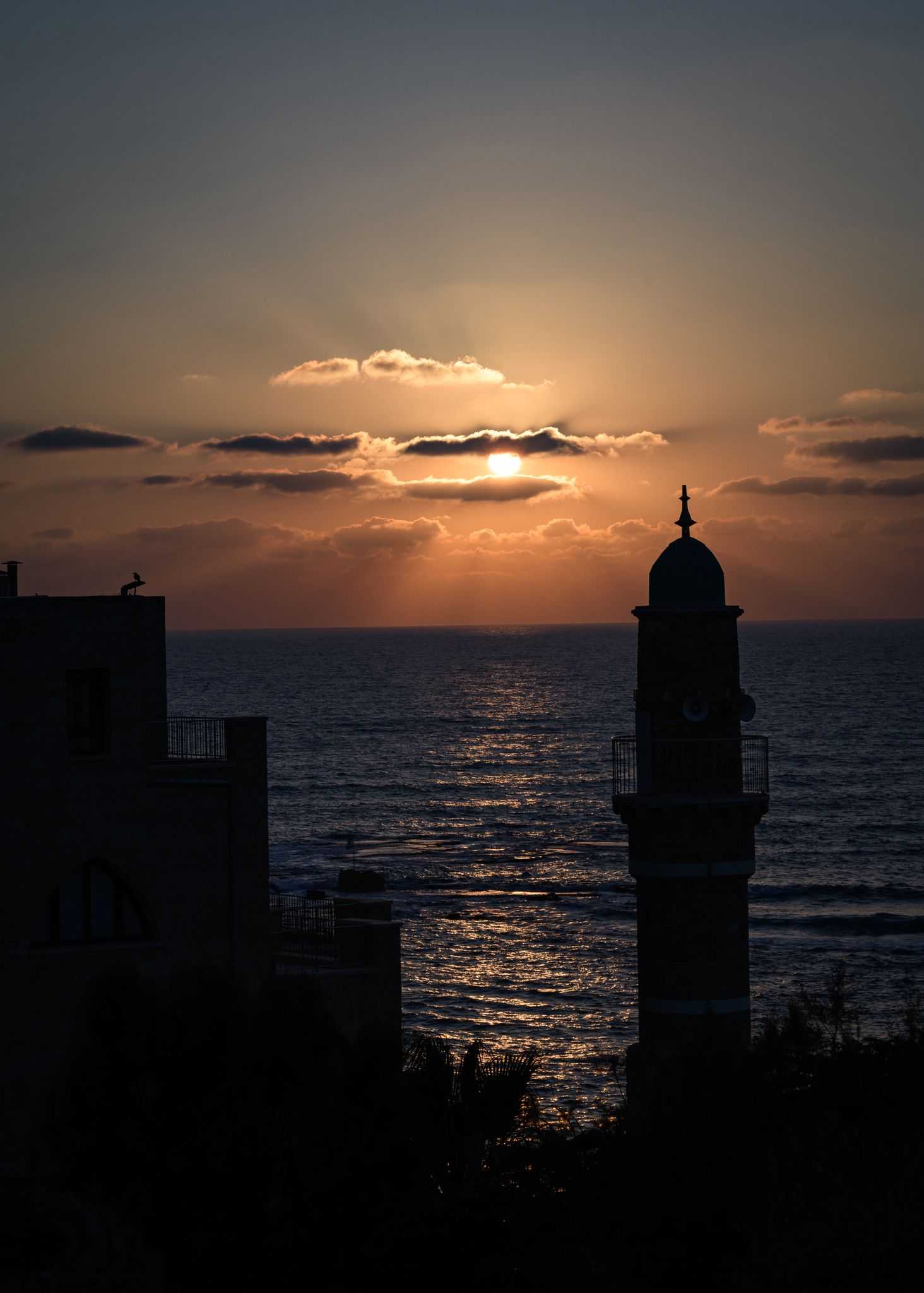 Jaffa at Dusk photograph by Shye Klein showing the sun setting over the Mediterranean Sea and Jaffa skyline