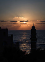 Jaffa at Dusk photograph by Shye Klein showing the sun setting over the Mediterranean Sea and Jaffa skyline