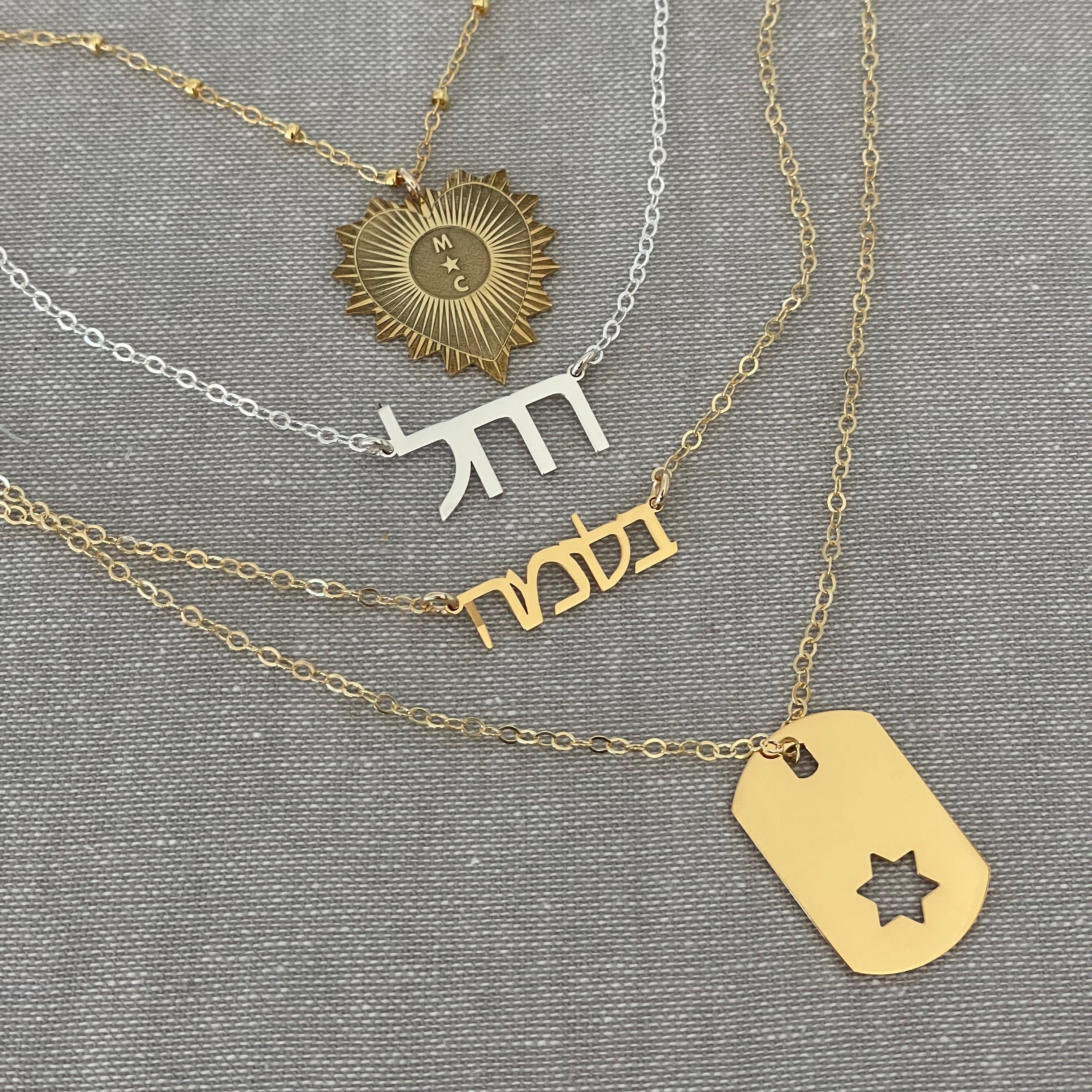 Gold Star of David dog tag necklace layered with Jewish jewelry