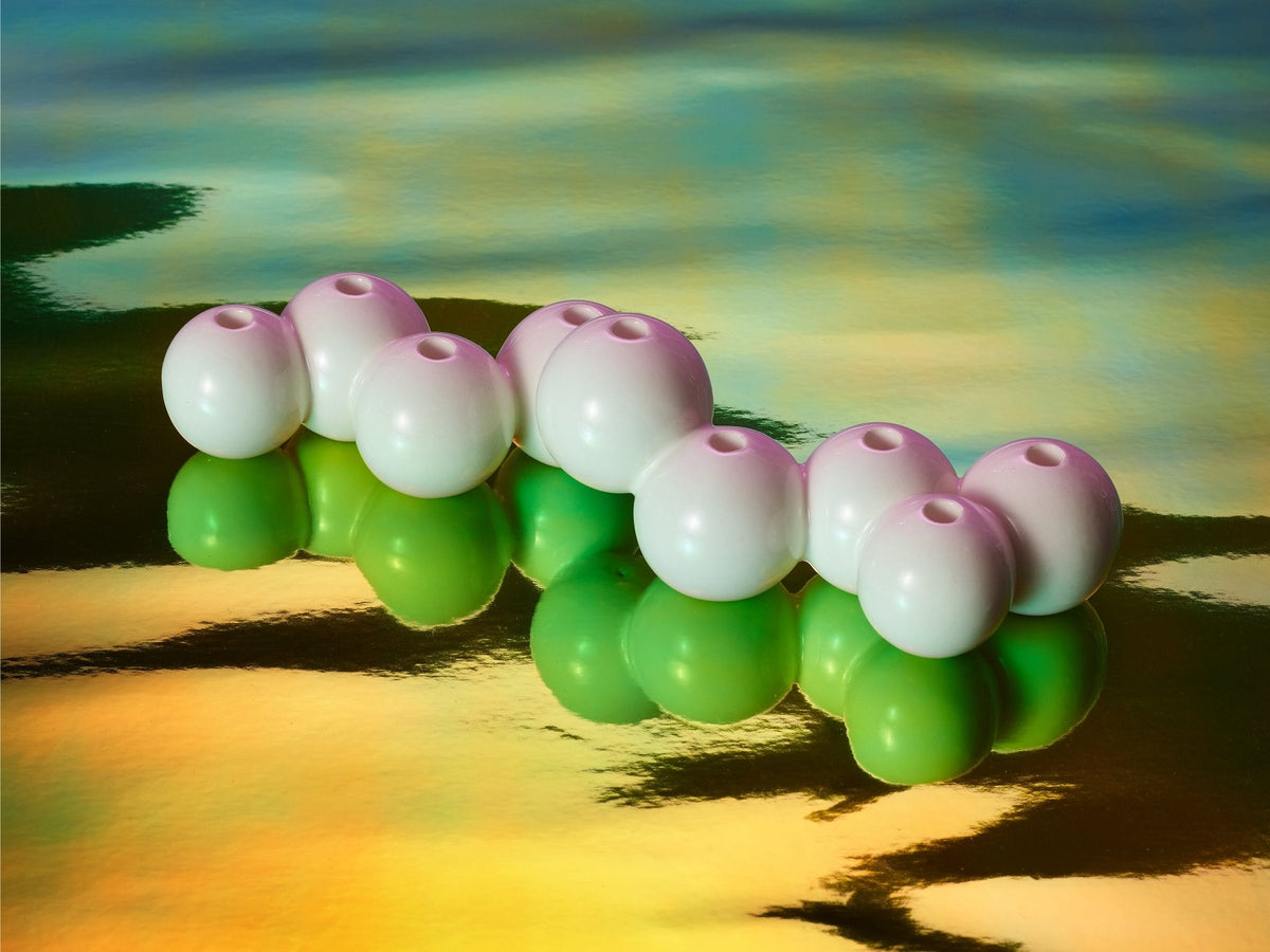 Stoneware Bubble Menorah shown from the side on a reflective surface