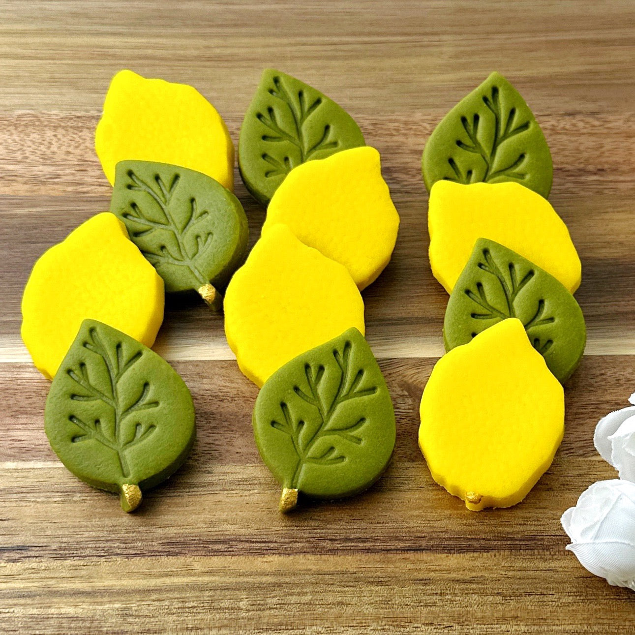 Handcrafted Sukkot marzipan etrogim and embossed green leaves by Marzipops