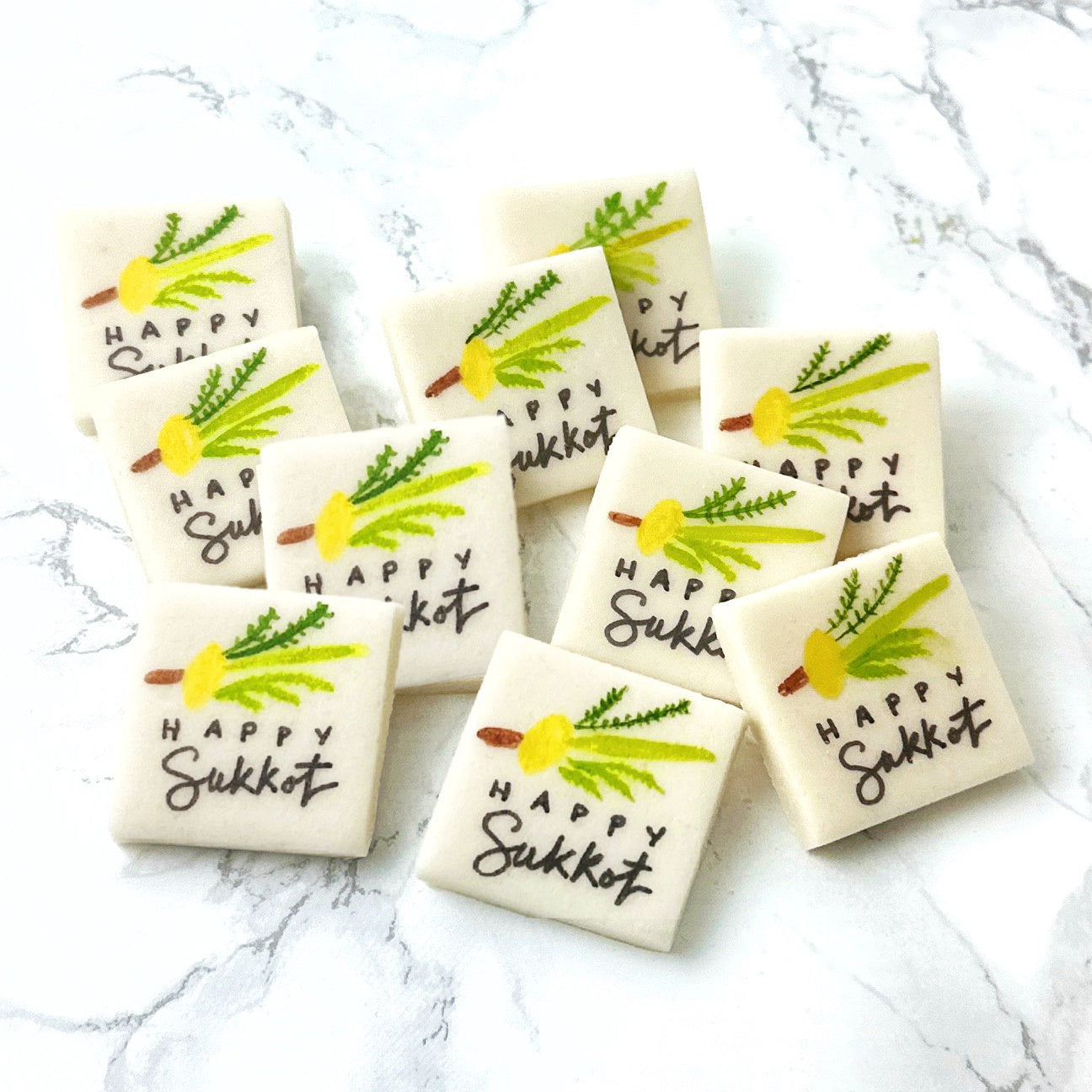 Assorted handcrafted Happy Sukkot marzipan place cards featuring the Four Species
