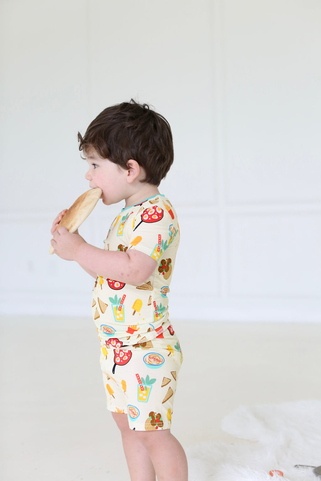 Side view of child wearing the Taste of Israel short-sleeve bamboo pajama set