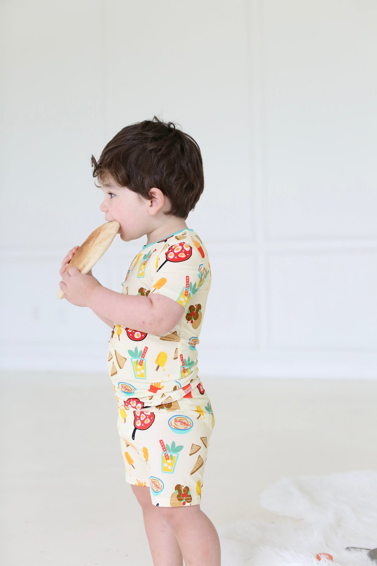 Side view of child wearing the Taste of Israel short-sleeve bamboo pajama set