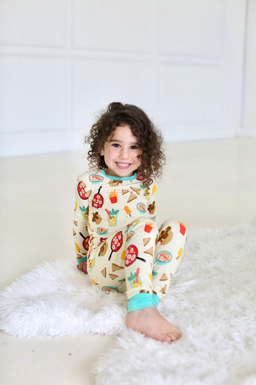 Child seated in the Taste of Israel two-piece pajama set