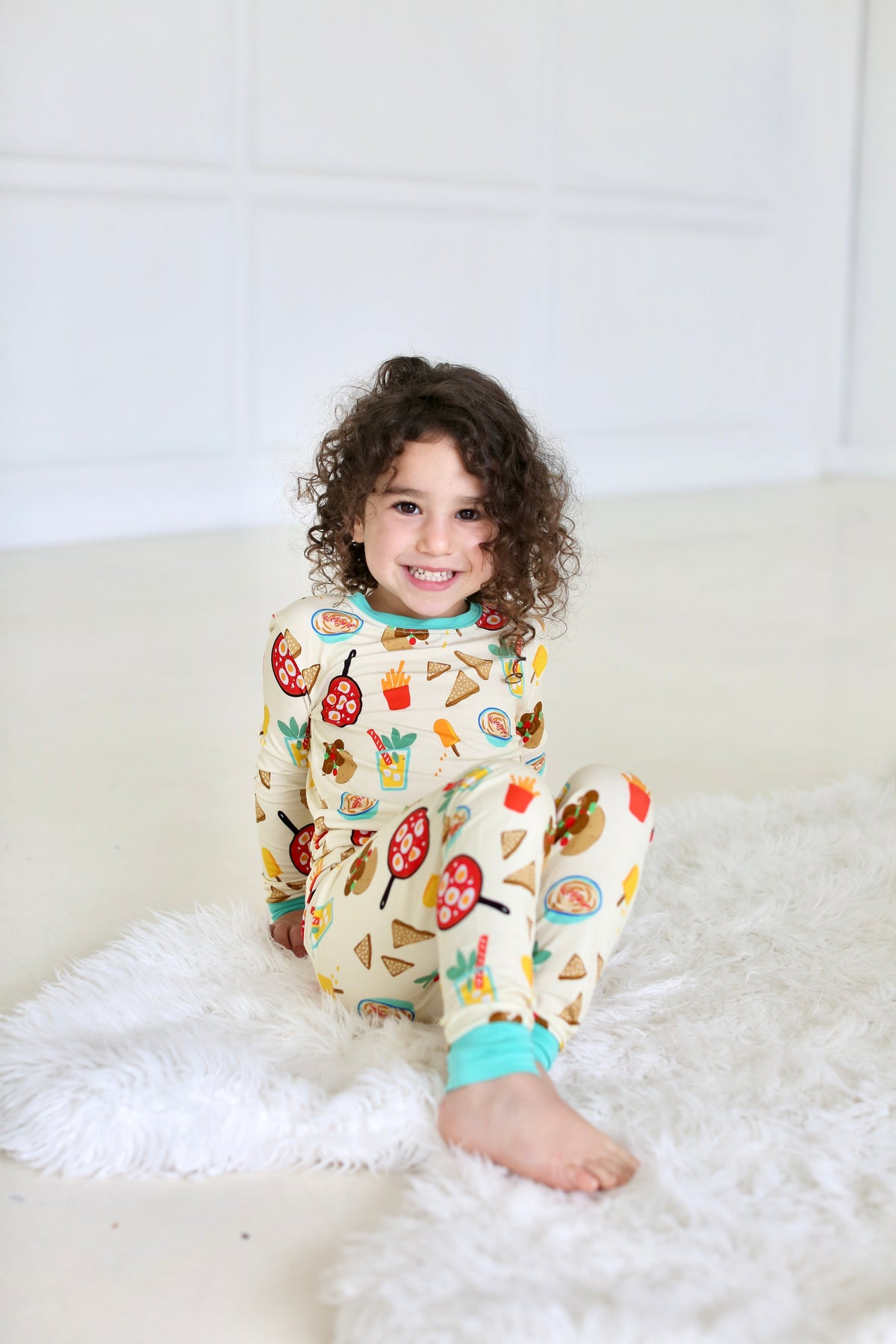 Child seated in the Taste of Israel two-piece pajama set