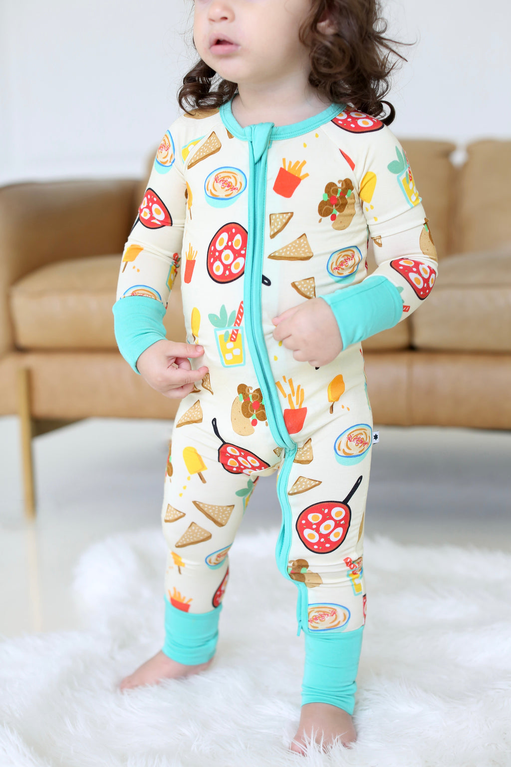 Full-length view of child wearing the Taste of Israel bamboo zippy by Shiloh & Kate