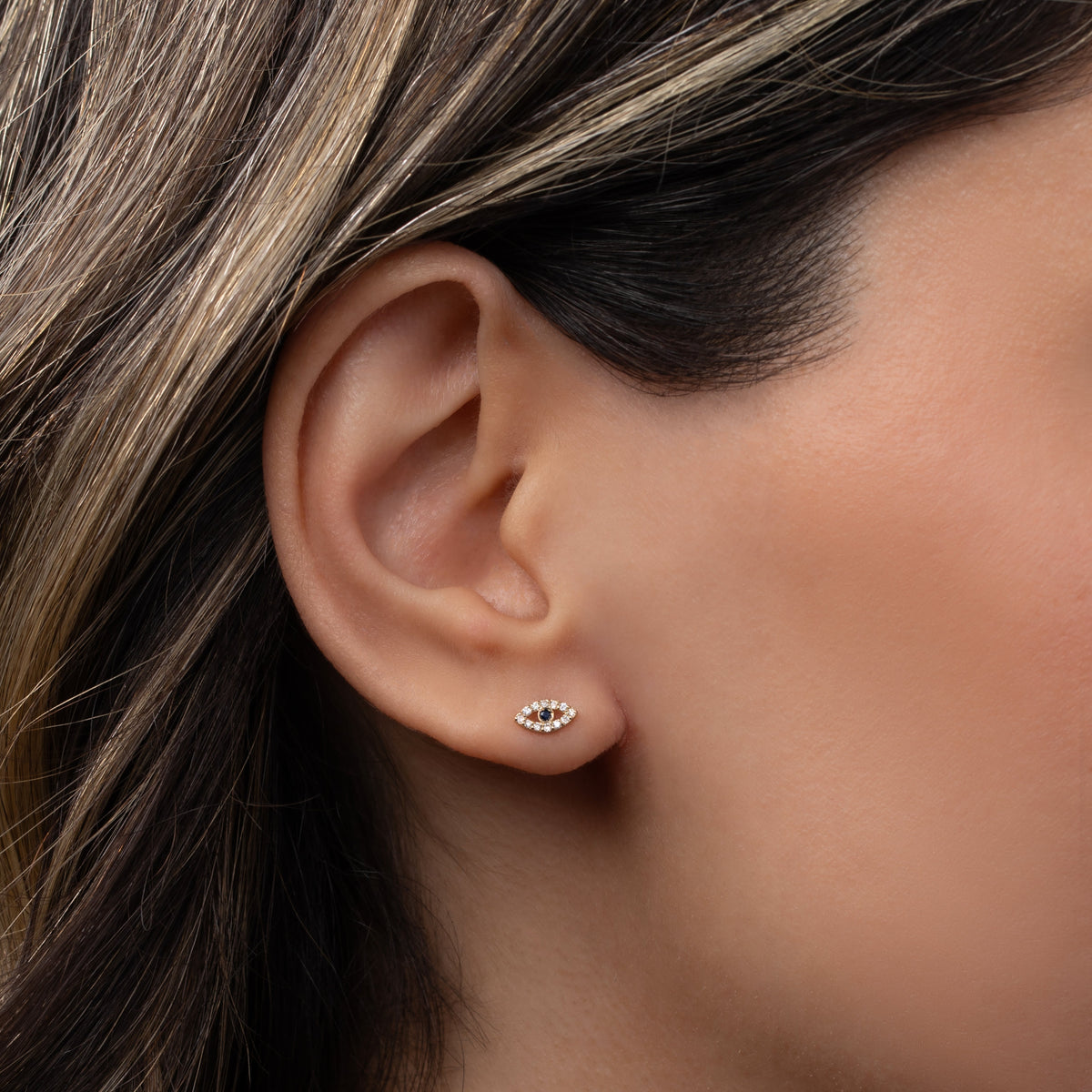 Tiny Diamond Evil Eye Stud Earring worn on ear