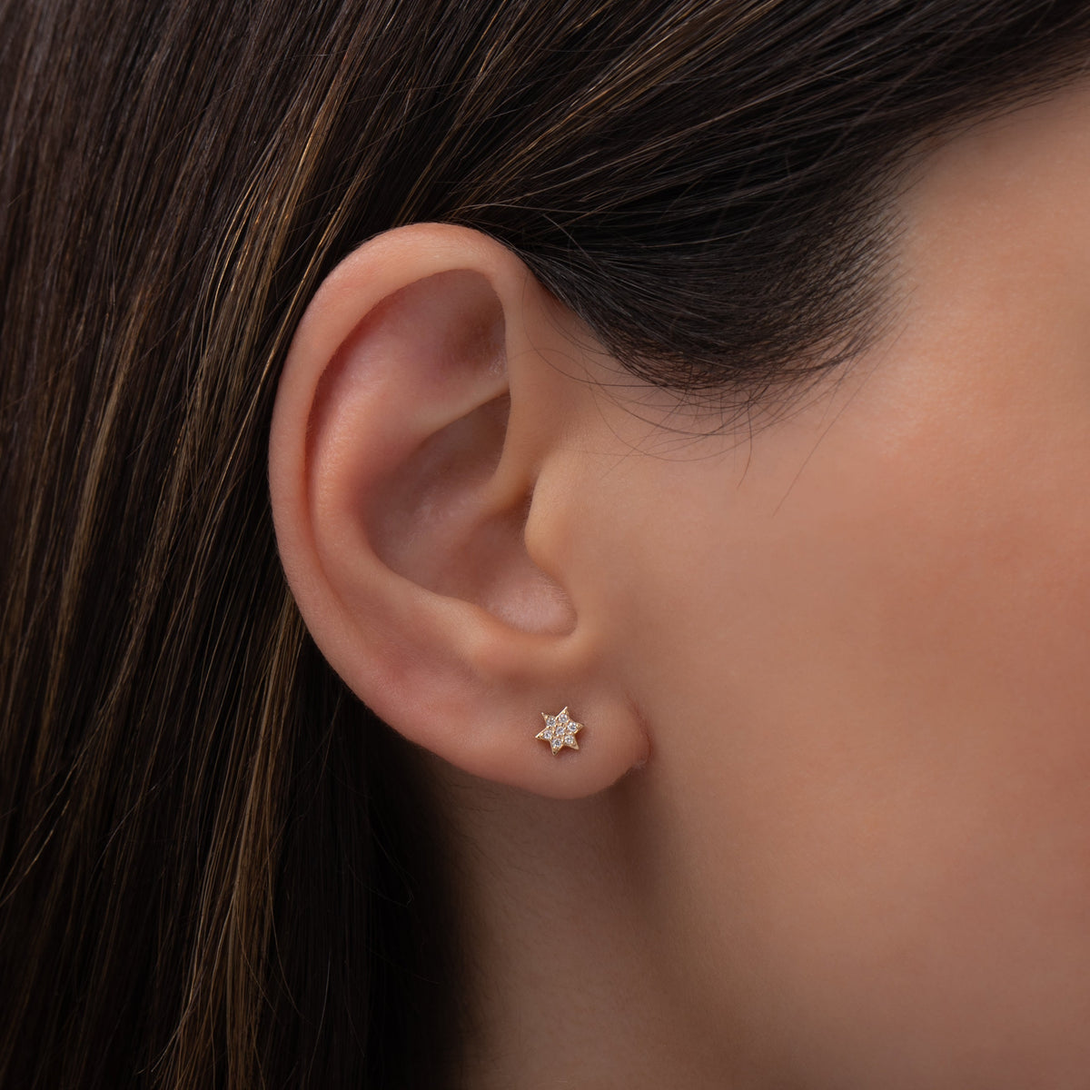 Tiny Diamond Star of David Stud Earring worn on ear
