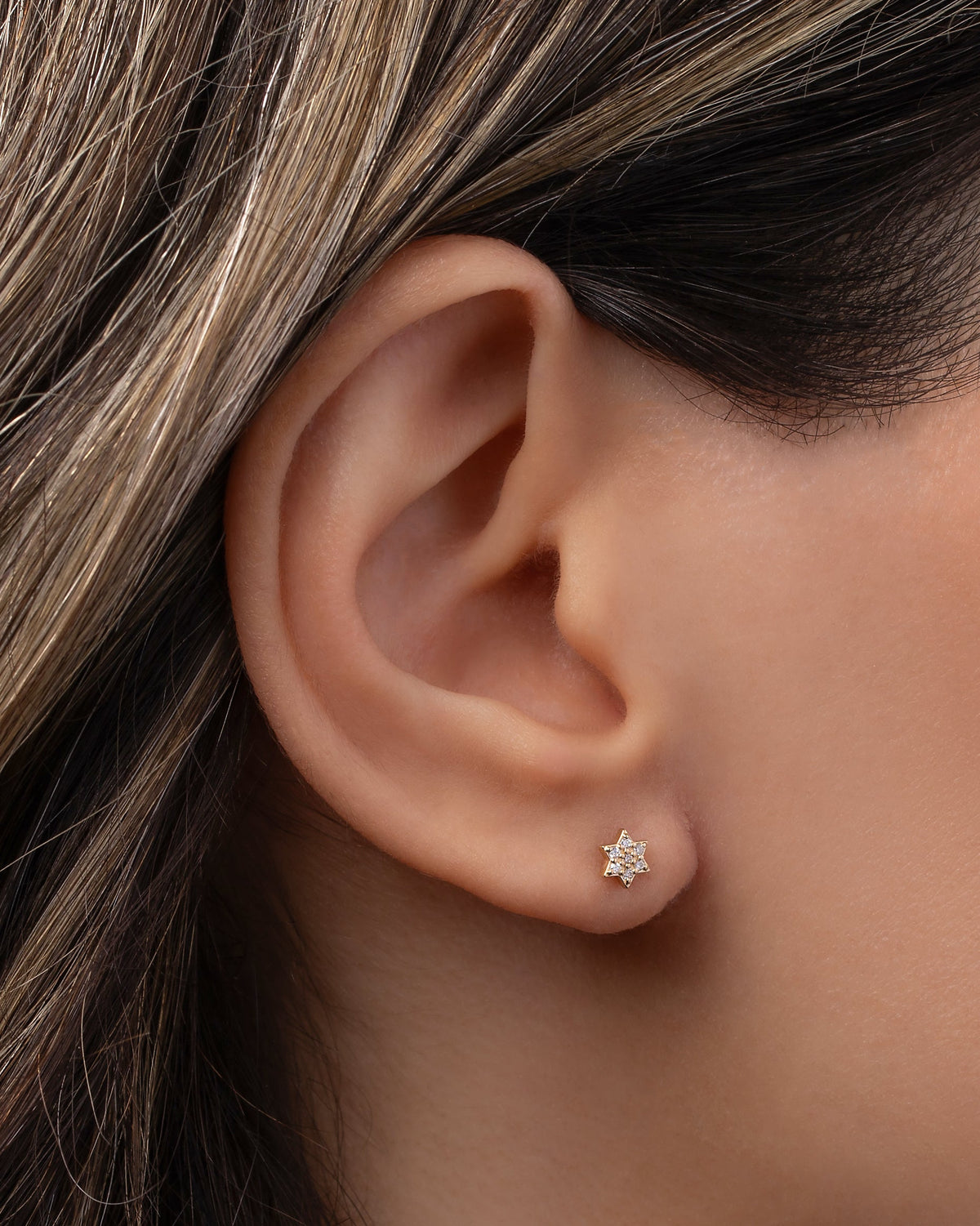 Tiny Diamond Star of David Stud Earring shown on ear for scale