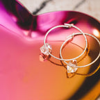 Heart-shaped trinket dish holding rings and earrings