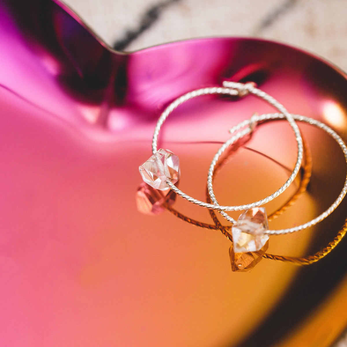 Heart-shaped trinket dish holding rings and earrings