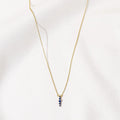 Gold Zen Necklace with five blue zircon stones by Shlomit Ofir