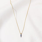 Gold Zen Necklace with five blue zircon stones by Shlomit Ofir