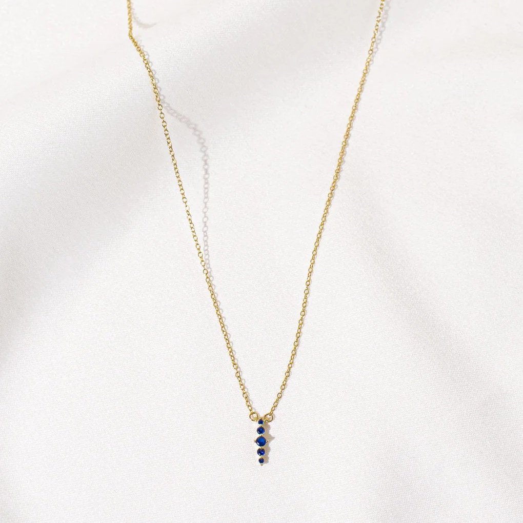 Gold Zen Necklace with five blue zircon stones by Shlomit Ofir